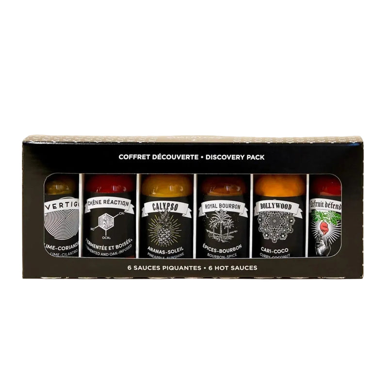 Packaging of hot sauce bottles with labels on a white background