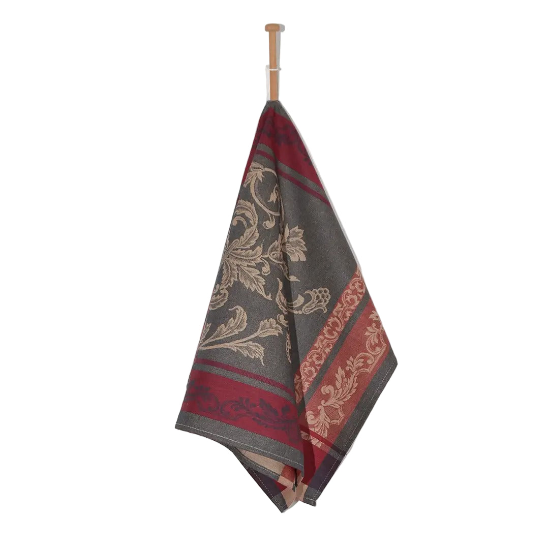Decorative towel with floral pattern on a wooden rod against a white background